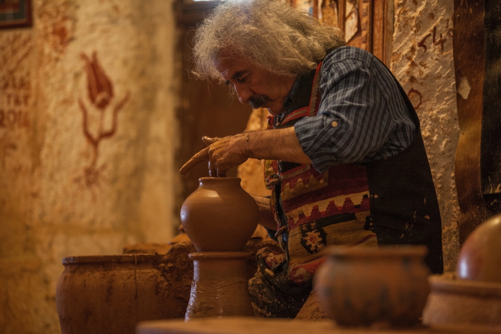 man working with clay as a demonstration of his cultural Heritage in the diaspora