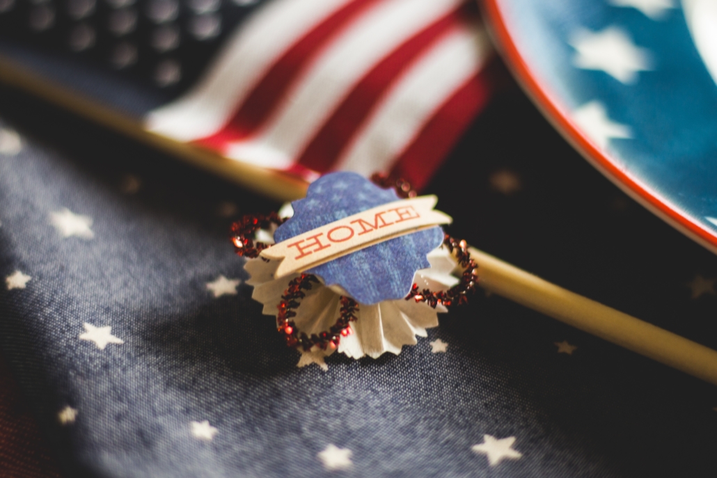 American diaspora hint, USA symbols including the flag, and a badge reading Home