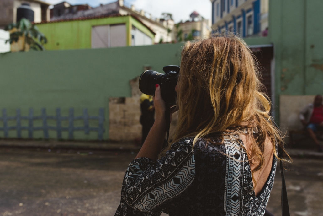 blond woman taking pictures in Havana, Cuba