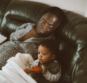 man sleeping next to his Cuban son