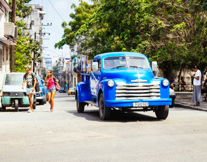 people using phones in the street in Cuba