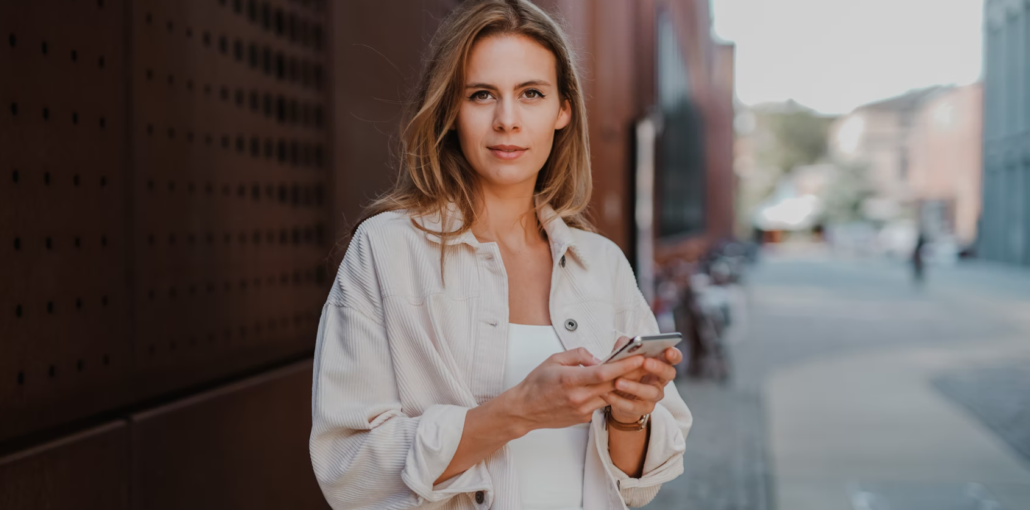 woman with a phone ready to make free mobile top ups