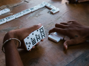Cubans playing domino while relatives send Cubacel top ups
