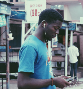 Manin Africa listening to music on Boomplay using the credit he received via a gift card from abroad.
