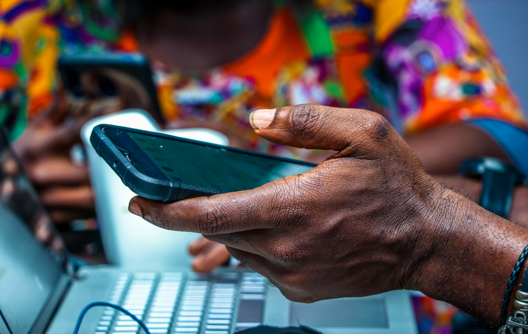 Nigerian man's hand holding a phone 