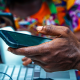 Nigerian man's hand holding a phone