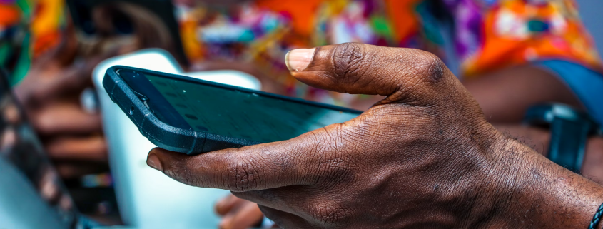 Nigerian man's hand holding a phone